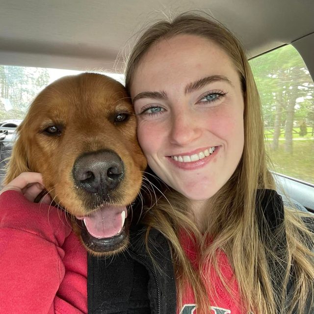 Sloan DeWare and a golden retriever in the car
