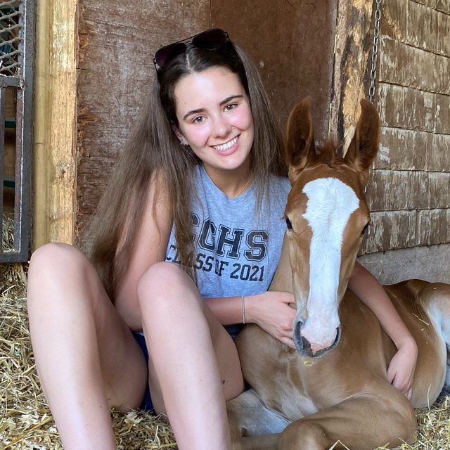 Alexis Mundle with a chestnut foal at her side