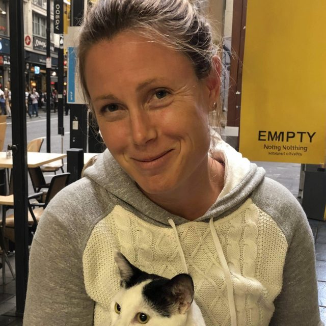 Dr. Jenny Murphy with a white and black cat on her lap